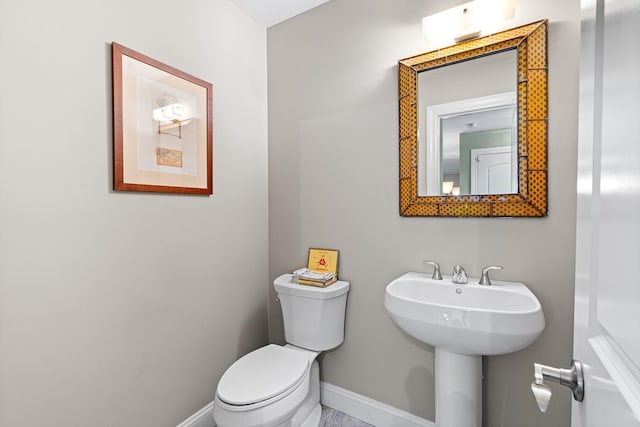 380 Hickory Rd, Southold, NY 11971 - bathroom with toilet, baseboards, and a sink