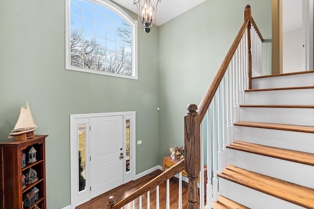 380 Hickory Rd, Southold, NY 11971 - foyer entrance featuring a chandelier, baseboards, wood finished floors, and stairs