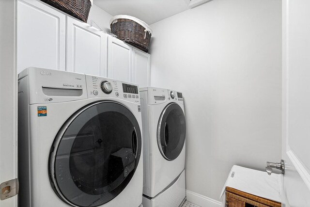 380 Hickory Rd, Southold, NY 11971 - laundry area with baseboards, cabinet space, and washing machine and clothes dryer