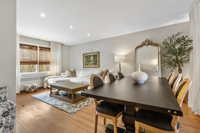 dining area with recessed lighting, radiator, and light wood-style floors