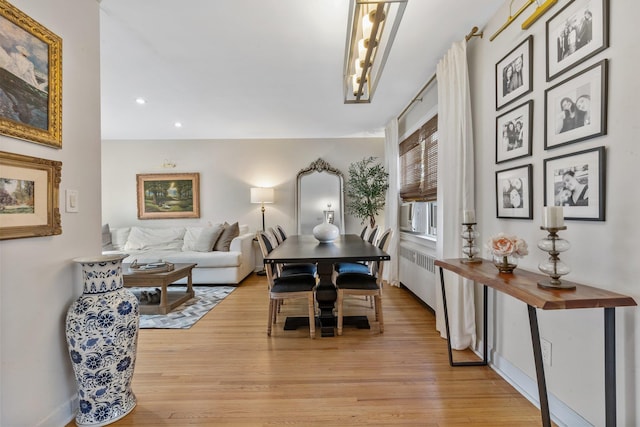 dining room featuring recessed lighting, radiator, light wood-type flooring, and baseboards