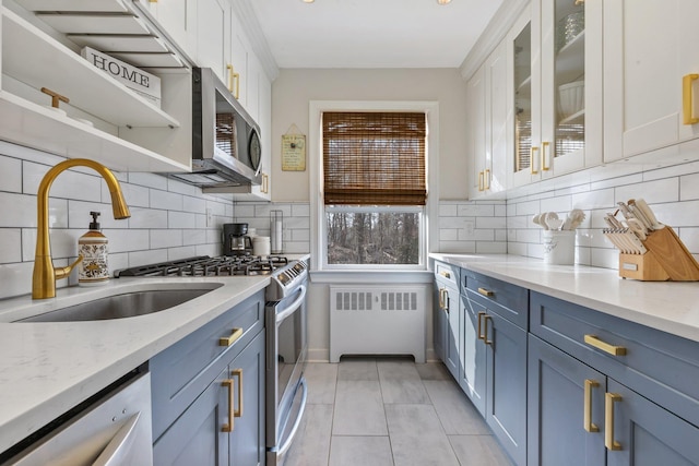 kitchen featuring dishwasher, stainless steel microwave, radiator, and white cabinetry