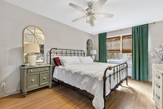 bedroom featuring baseboards, a ceiling fan, and light wood-style floors