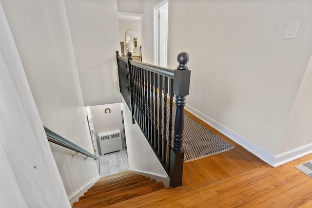 stairway with hardwood / wood-style flooring, visible vents, and baseboards