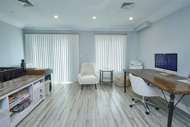 office space with light wood-type flooring, visible vents, and recessed lighting