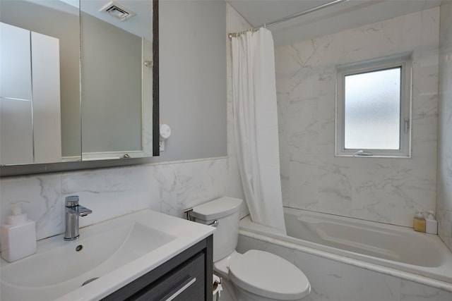 full bathroom with toilet, tile walls, vanity, visible vents, and shower / bathtub combination with curtain