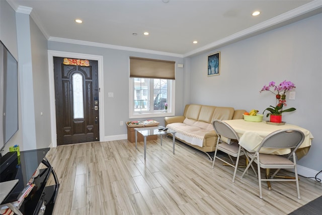 entrance foyer featuring light wood finished floors, baseboards, ornamental molding, and recessed lighting