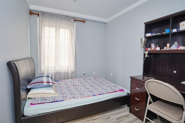 bedroom featuring light wood finished floors and ornamental molding