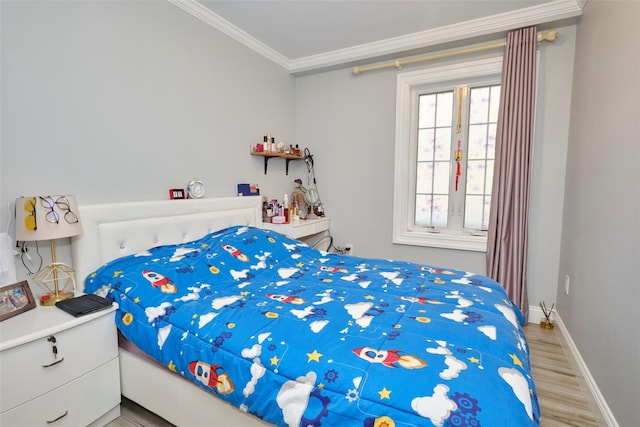 bedroom with ornamental molding, light wood-type flooring, and baseboards