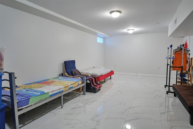 bedroom with marble finish floor, visible vents, and baseboards