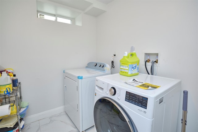 laundry room with laundry area, independent washer and dryer, marble finish floor, and baseboards