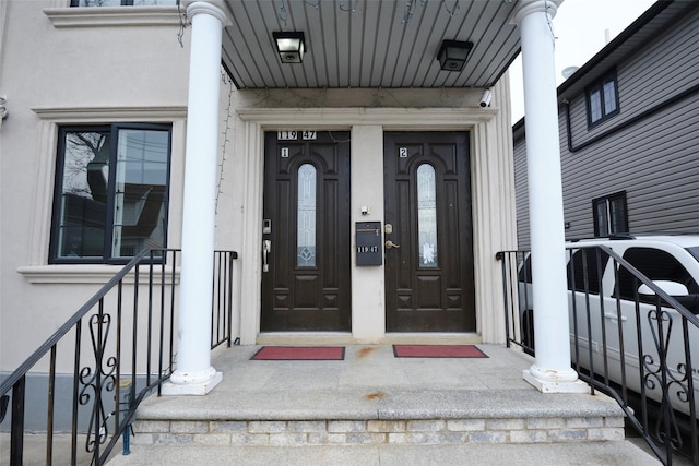 entrance to property with stucco siding