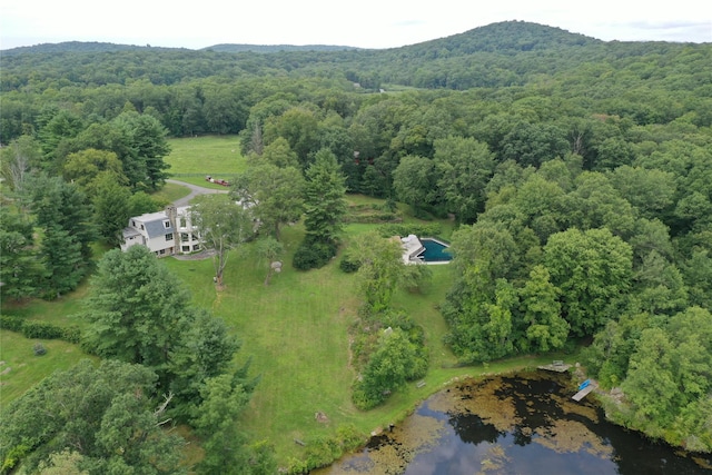 aerial view with a forest view and a water view