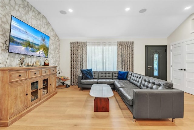 living area featuring light wood-type flooring, vaulted ceiling, and recessed lighting