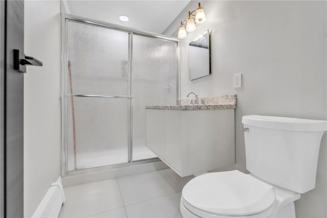 bathroom featuring toilet, a stall shower, vanity, and tile patterned floors