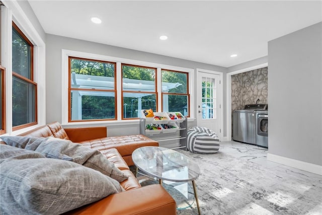 living area with recessed lighting, marble finish floor, plenty of natural light, and washing machine and clothes dryer