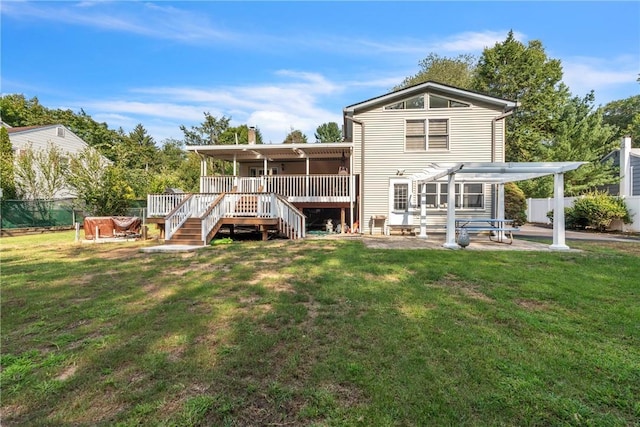 back of property featuring fence, a lawn, and a wooden deck