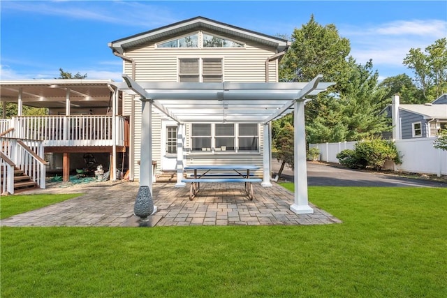 back of property with a lawn, a patio area, fence, a deck, and a pergola