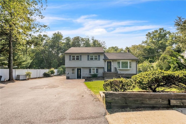 tri-level home featuring fence