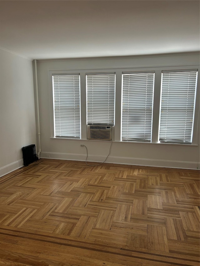 spare room featuring cooling unit and baseboards