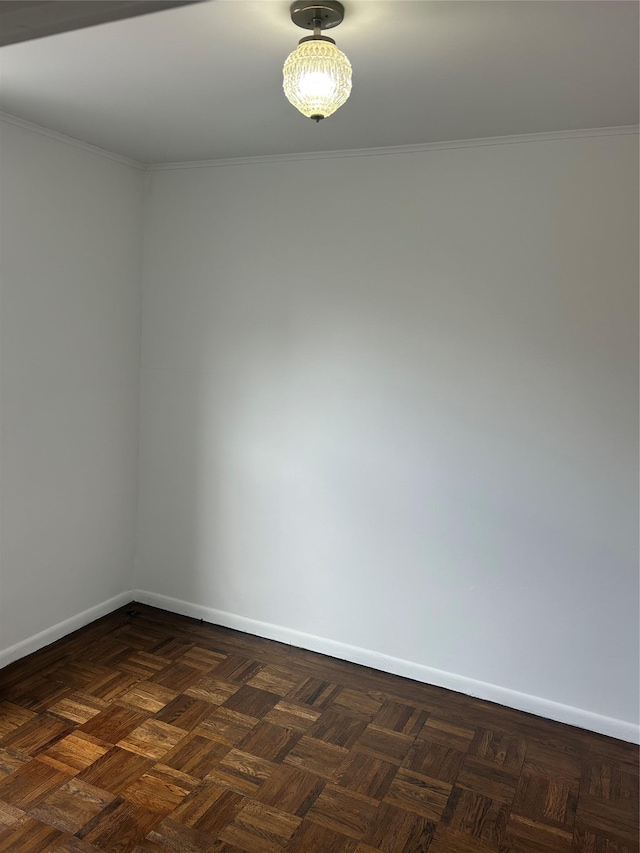 spare room featuring crown molding and baseboards