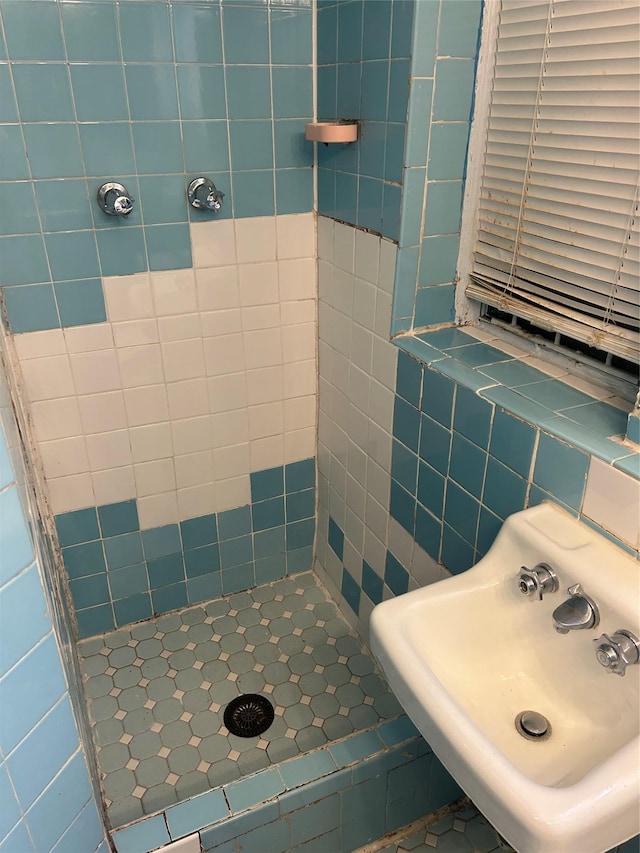 full bath with a stall shower and a sink