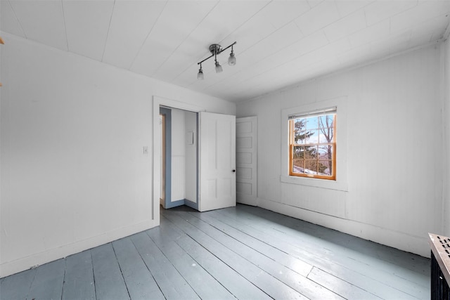 empty room featuring hardwood / wood-style floors and baseboards