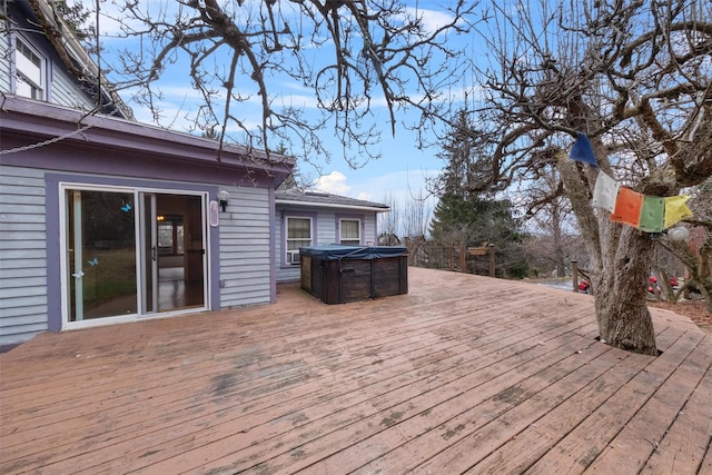 wooden deck featuring a hot tub