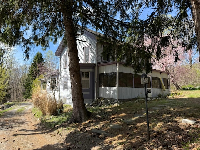 view of side of property with a sunroom