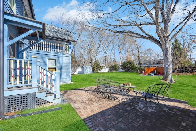 view of patio / terrace with an outdoor structure and a storage unit