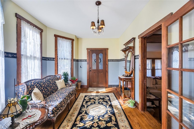 foyer entrance featuring an inviting chandelier and light wood-style floors