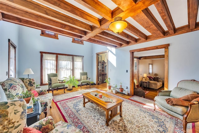 living room with wood finished floors and beam ceiling