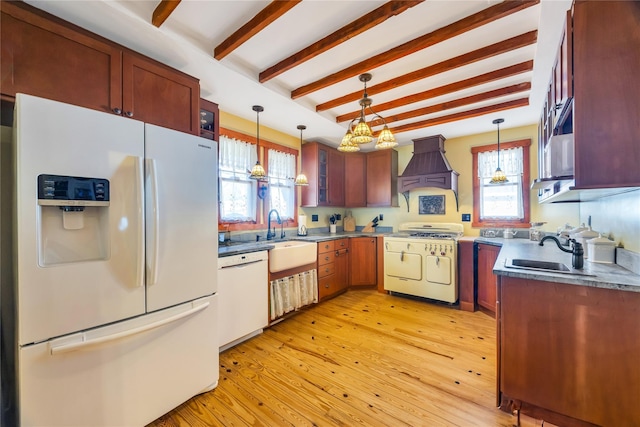 kitchen featuring white appliances, premium range hood, light wood-style flooring, and a sink