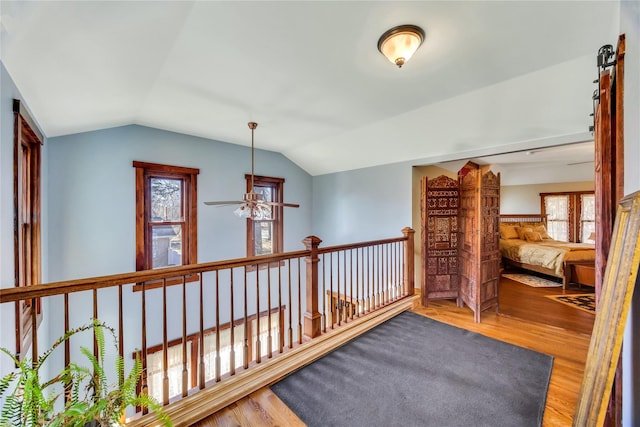 hallway featuring lofted ceiling and wood finished floors