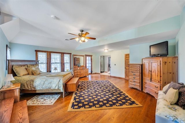 bedroom with visible vents, light wood-type flooring, and a ceiling fan