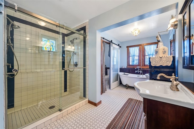 bathroom with a shower stall, baseboards, a freestanding bath, and vanity