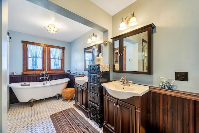 bathroom featuring a soaking tub and vanity