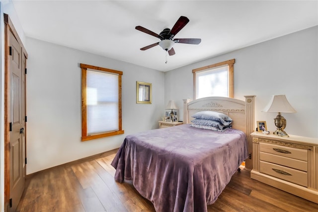 bedroom featuring ceiling fan, wood finished floors, and baseboards