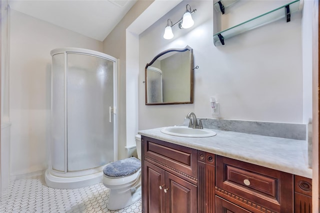 bathroom featuring a stall shower, tile patterned flooring, vanity, and toilet