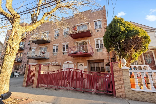 exterior space featuring a fenced front yard and brick siding