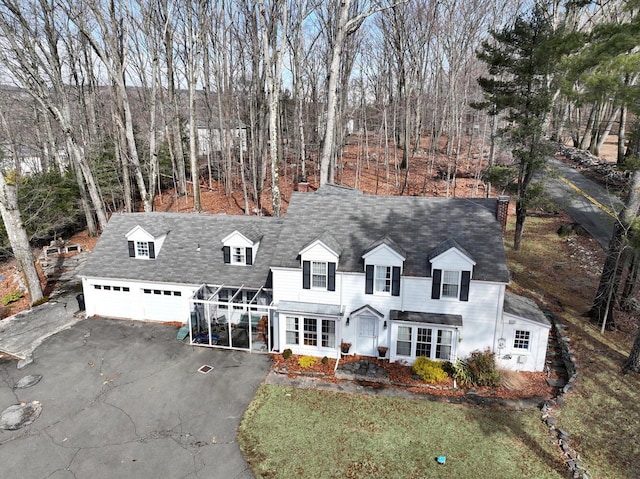 cape cod-style house with aphalt driveway and a garage