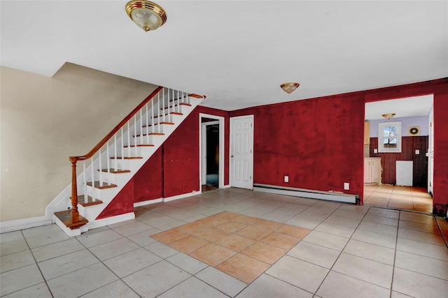 foyer entrance with light tile patterned floors, stairs, baseboards, and baseboard heating