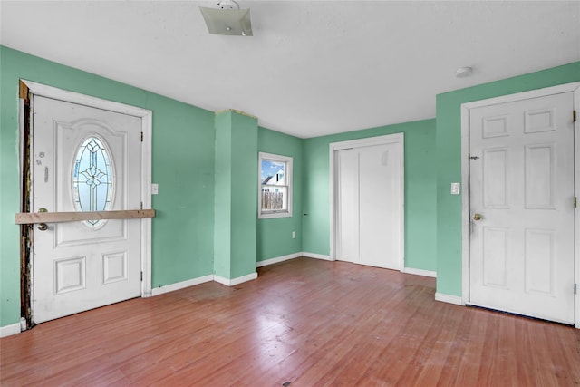 entrance foyer featuring baseboards and wood finished floors