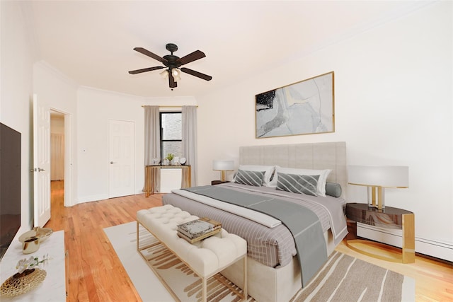 bedroom with light wood finished floors, ceiling fan, baseboards, and ornamental molding