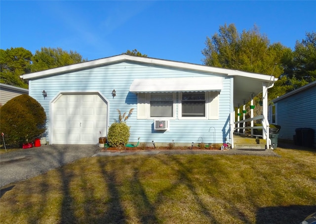 view of front facade with a garage, a front lawn, and aphalt driveway