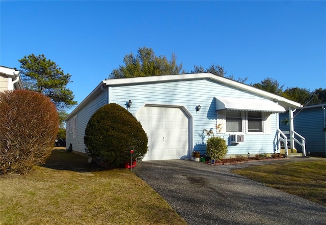 view of front facade with a garage, a front yard, cooling unit, and driveway