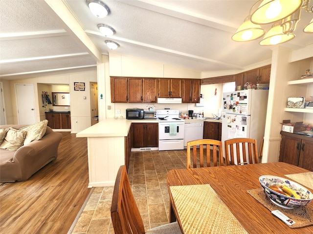 kitchen with under cabinet range hood, a peninsula, white appliances, open floor plan, and light countertops