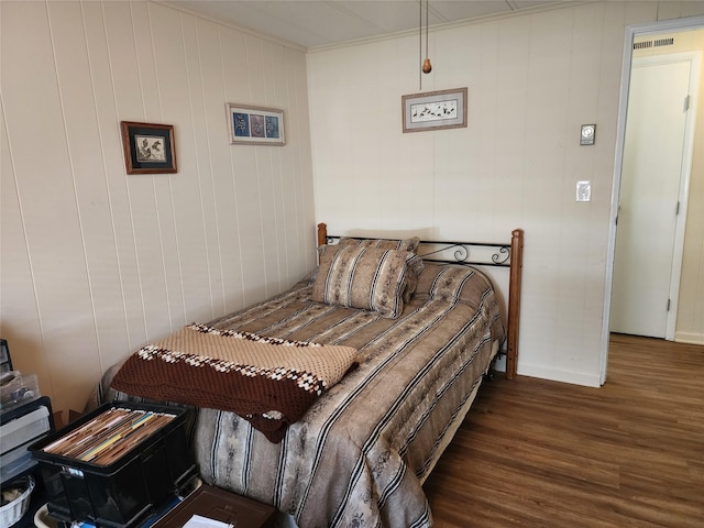 bedroom featuring wood finished floors and baseboards