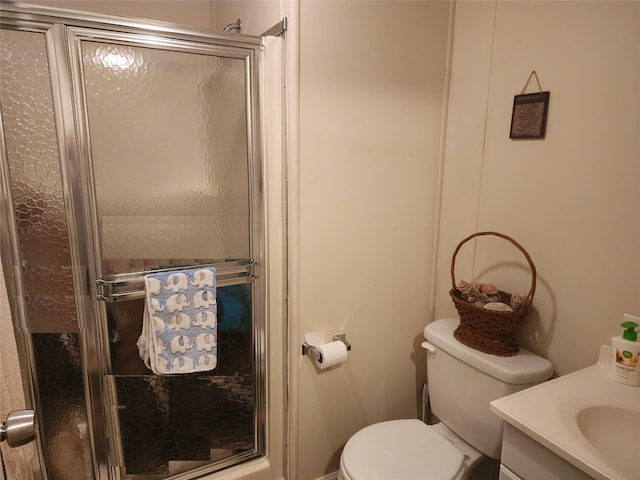 bathroom featuring a stall shower, vanity, and toilet