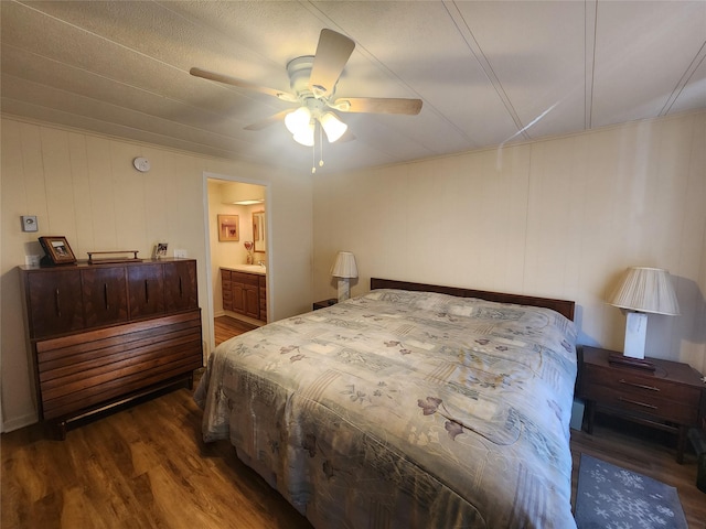 bedroom featuring ceiling fan, wood finished floors, and connected bathroom